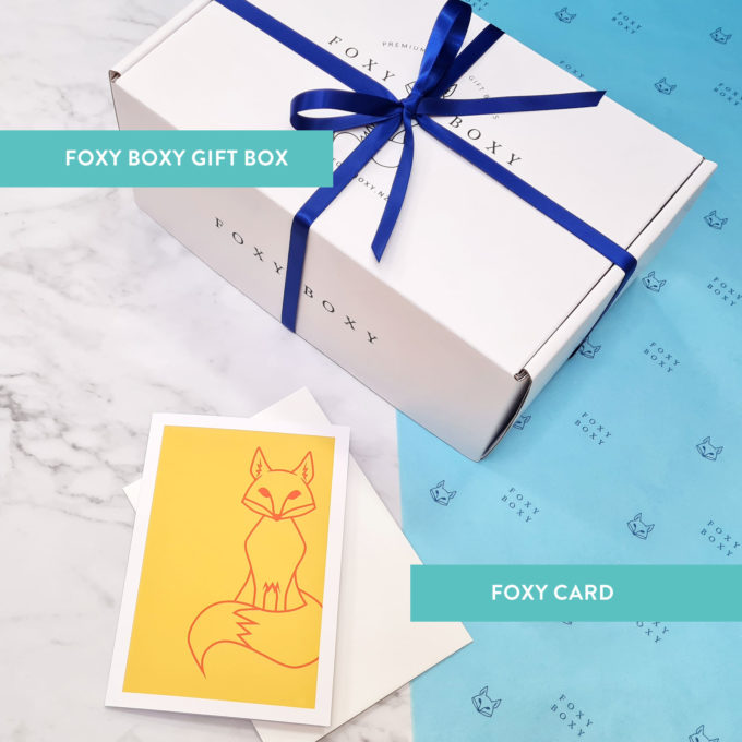 FOXY BOXY gift box with blue ribbon and FOXY card in yellow