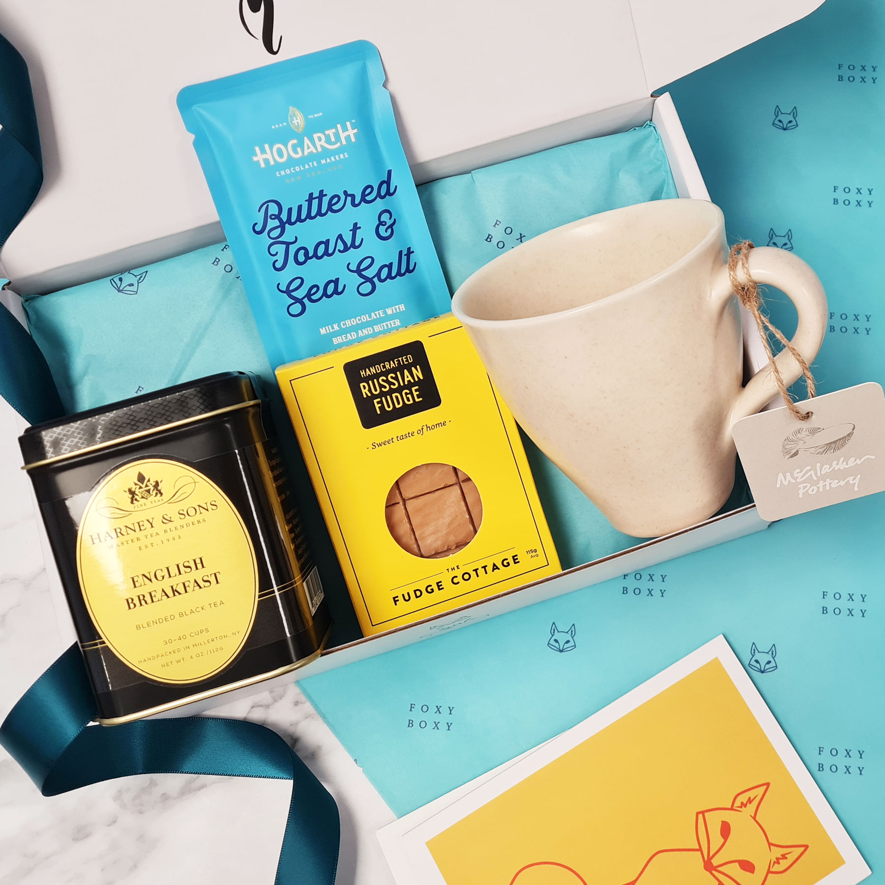 FOXY-BOXY-lovely-to-a-tea-gift-box-english-breakfast-nz-pottery-mug Lovely To A Tea gift box. Features tin of Harney & Sons English breakfast tea, NZ Pottery mug from McGlashen Pottery, award-winning NZ craft chocolate and melt in your mouth russian fudge.