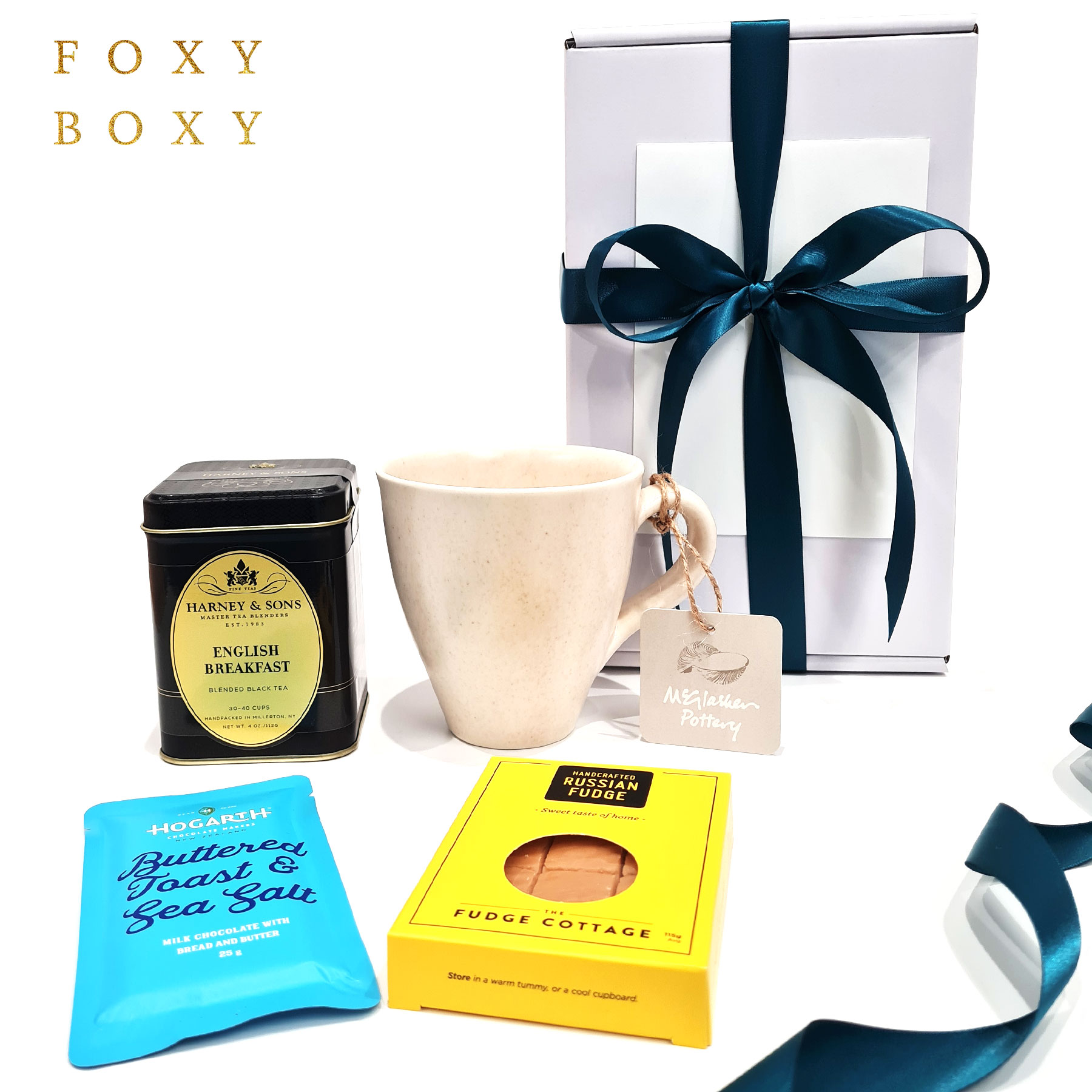 FOXY-BOXY-lovely-to-a-tea-gift-hamper-box-english-breakfast-tea-nz-pottery-mug-2025 Lovely To A Tea gift box. Features tin of Harney & Sons English breakfast tea, NZ Pottery mug from McGlashen Pottery, award-winning NZ craft chocolate and melt in your mouth russian fudge.