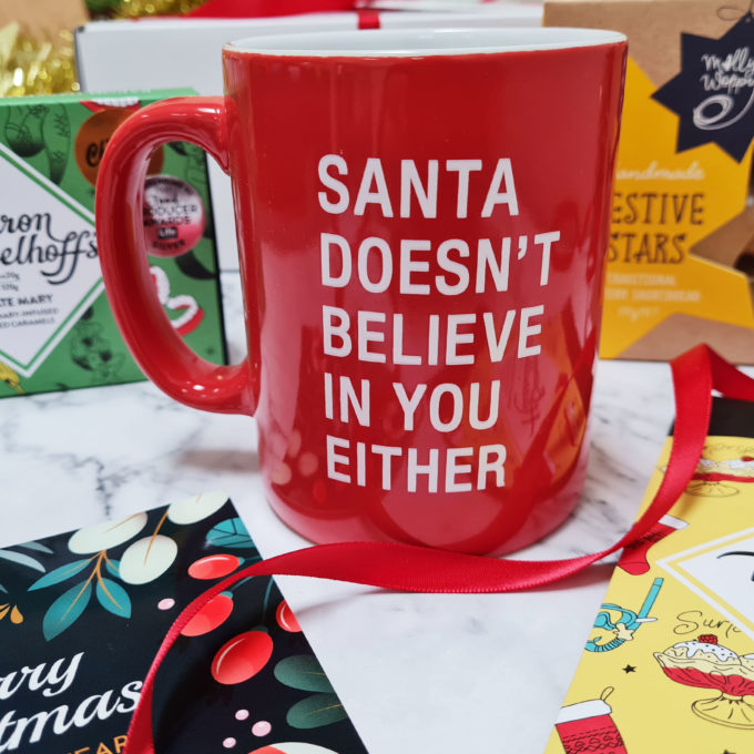 Christmas red mug with message: "Santa doesn't believe in you either"