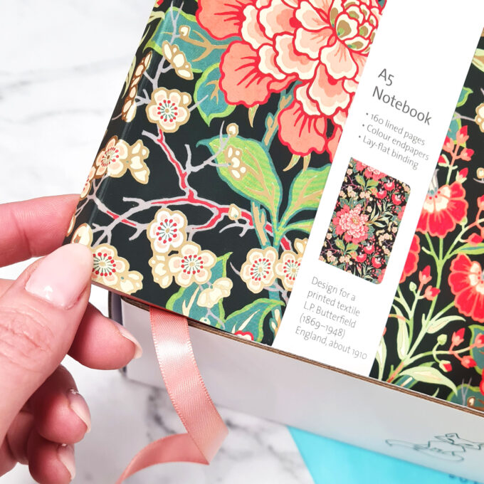 Notebook closeup to show the beautiful floral design with gold foil.