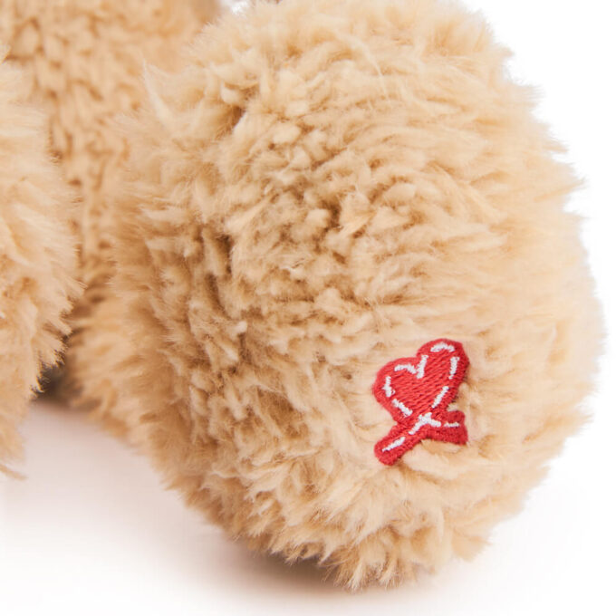 Toothpick and has a red stitch heart on his left paw